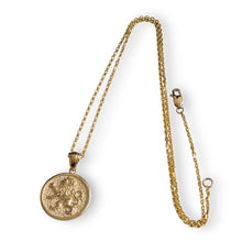Gold necklace with a pendant on a white background