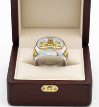 Silver and gold  menorah ring in a wooden box with a beige interior