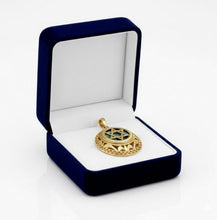 Gold pendant with star design in a blue jewelry box on a white background