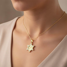 Gold necklace with a Star of David pendant on a neutral background