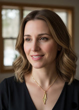 Woman wearing map of Israel pendant in gold 