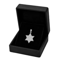 A silver Star of David pendant with a textured pavé pattern, displayed inside an open black jewelry box on a black velvet cushion, set against a plain white background.