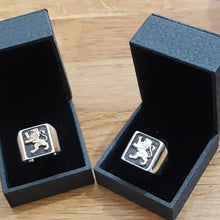 A 925 sterling silver ring with a 9k gold Lion of Judah design on top.