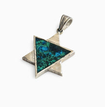 Silver pendant with a green triangular stone on a white background