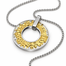 A silver and gold circular pendant necklace with a textured, geometric gold center and a silver outer ring accented with small clear stones, shown on a white background.