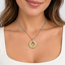 Woman wearing a two tone Jerusalem pendant necklace with gold city design 