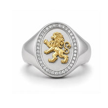 Silver ring with a gold lion emblem on a white background