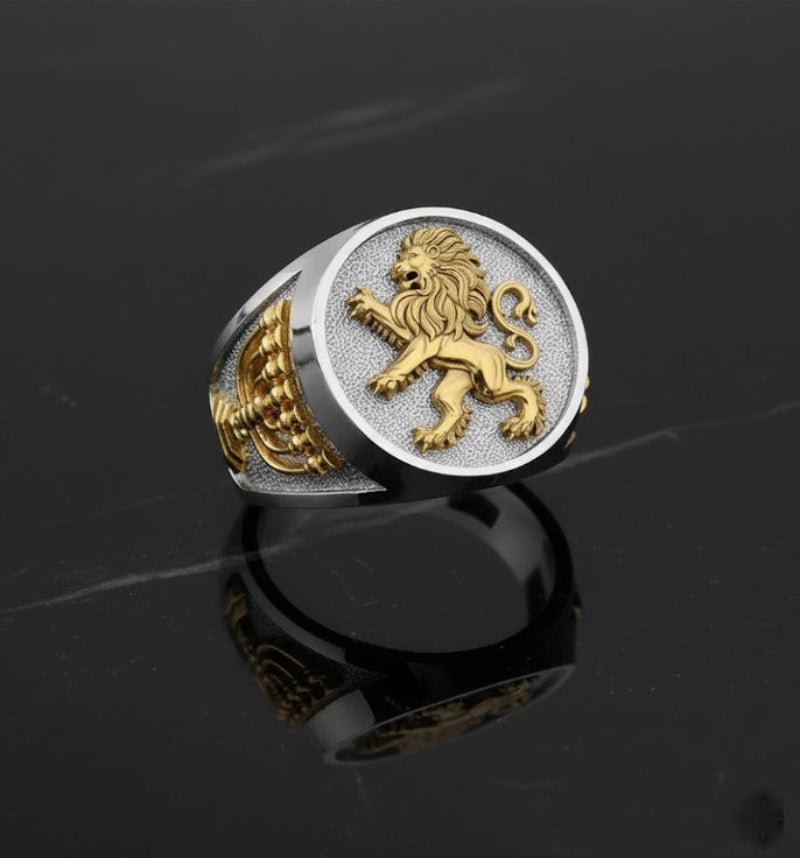 Gold and silver ring with a lion of Judah emblem on a black background