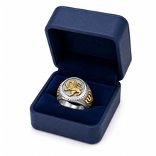 Gold and silver ring with lion emblem in a blue box on a white background