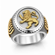 Gold and silver ring with a lion emblem on a white background