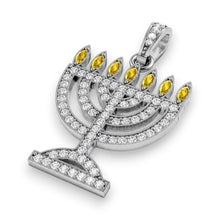 Silver Menorah pendant with yellow and clear stones on a white background