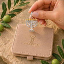 Jewelry box with 'Yoels Jewelry' logo and a Menorah pendant held above it.