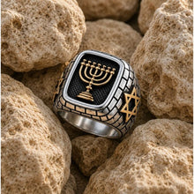 Silver ring with gold Menorah and Star of David on a white background