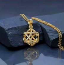 Gold pendant with star david design on a black background