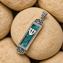 handmade mezuzah necklace on stone background