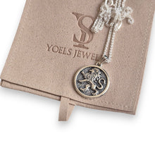 Silver necklace with a lion pendant on a Yoels Jewel box