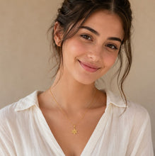 Young Woman Wearing Delicate Gold Star of David Chai Necklace