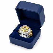 Silver and gold ring with star design in a blue box on a white background