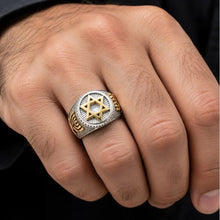 Close-up of a hand wearing a gold and silver ring with a Star of David design.