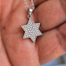 14K white gold Star of David pendant with lab grown diamonds held by woman hand 