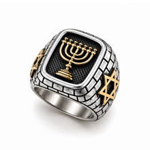 Silver ring with gold Menorah and Star of David on a white background