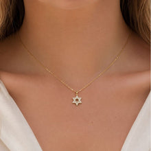 Tiny 14K gold diamonds Star of David necklace worn by woman