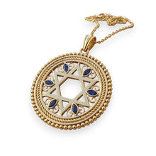 Gold pendant with Star of David design and blue stones on a white background